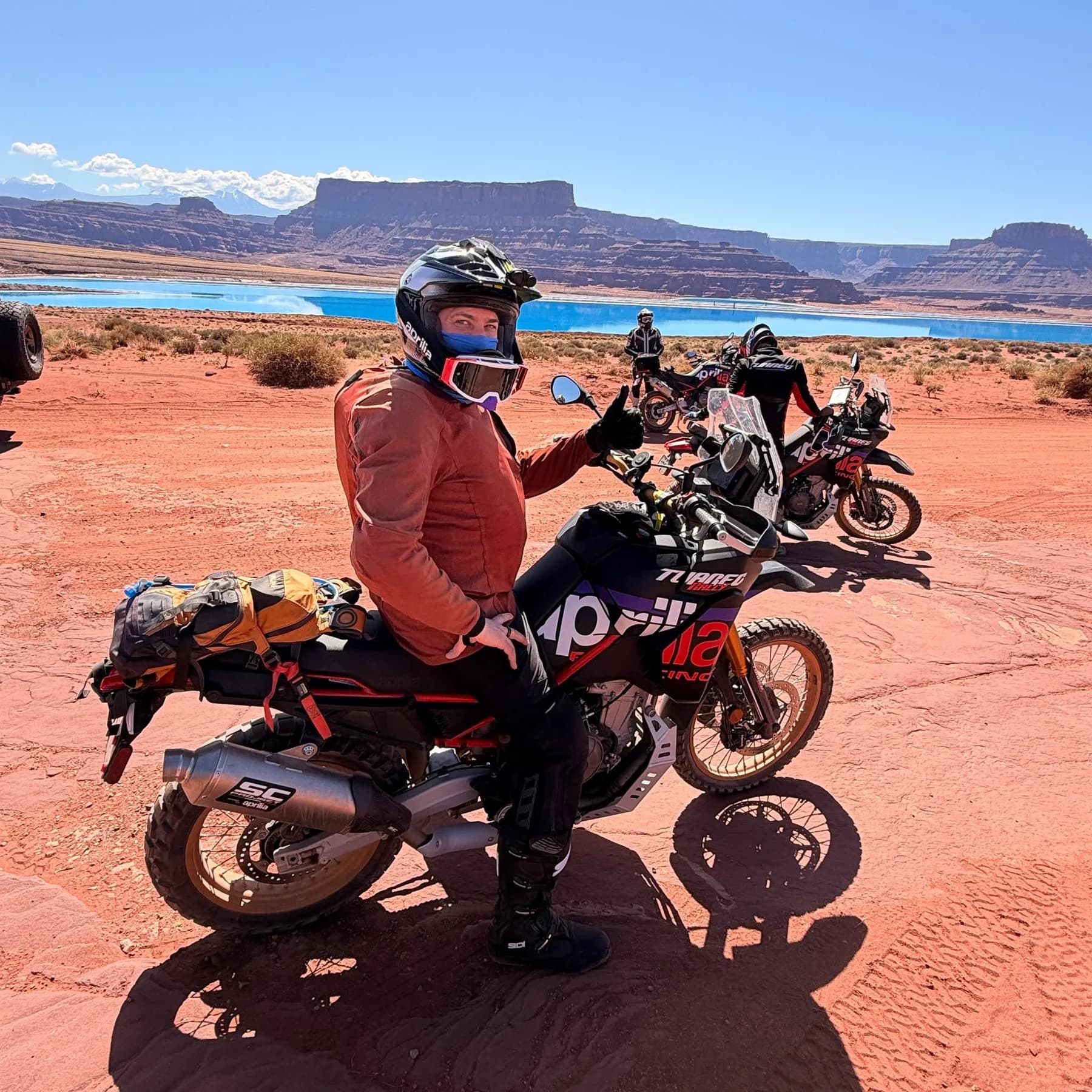 Aaron Hudson with expedition riders and motorcycles in the field